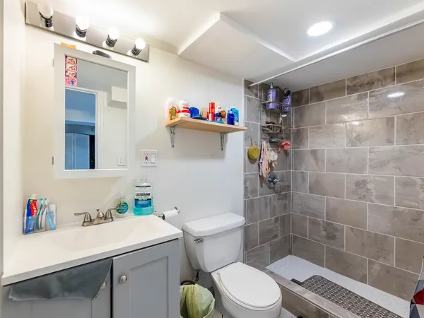 a bathroom with a sink toilet and shower