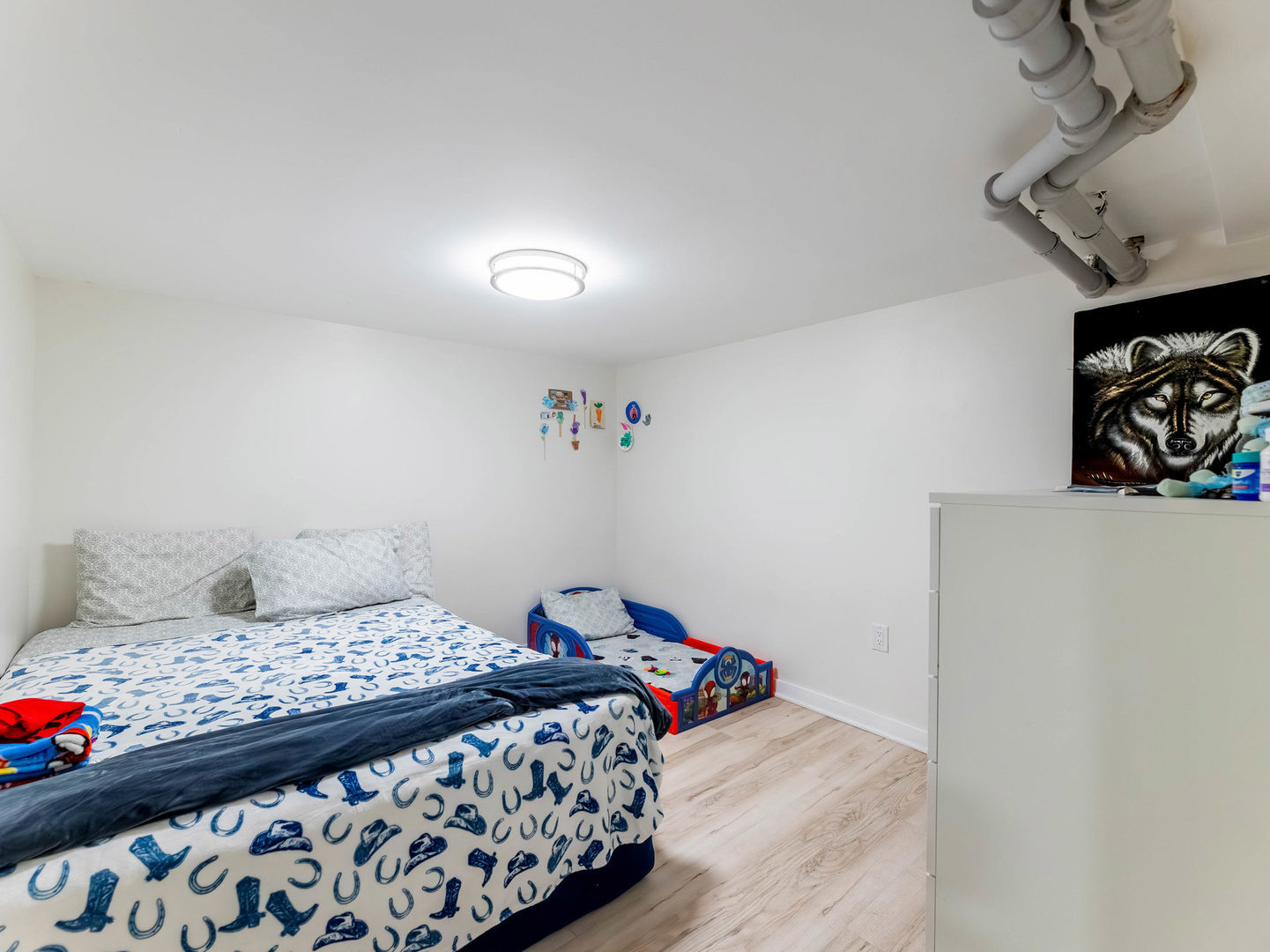 4747 West Monroe Street Chicago, IL 60644 - Photo 21 of 25 a bedroom with a bed and wooden floor