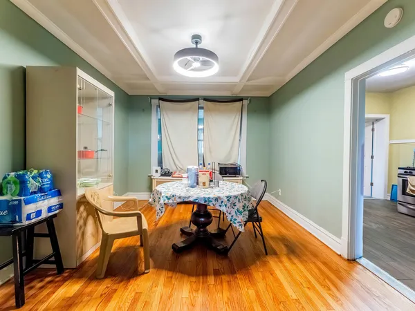 a view of a dining room with furniture and wooden floor