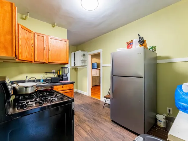 a kitchen with stainless steel appliances granite countertop a refrigerator stove and a sink