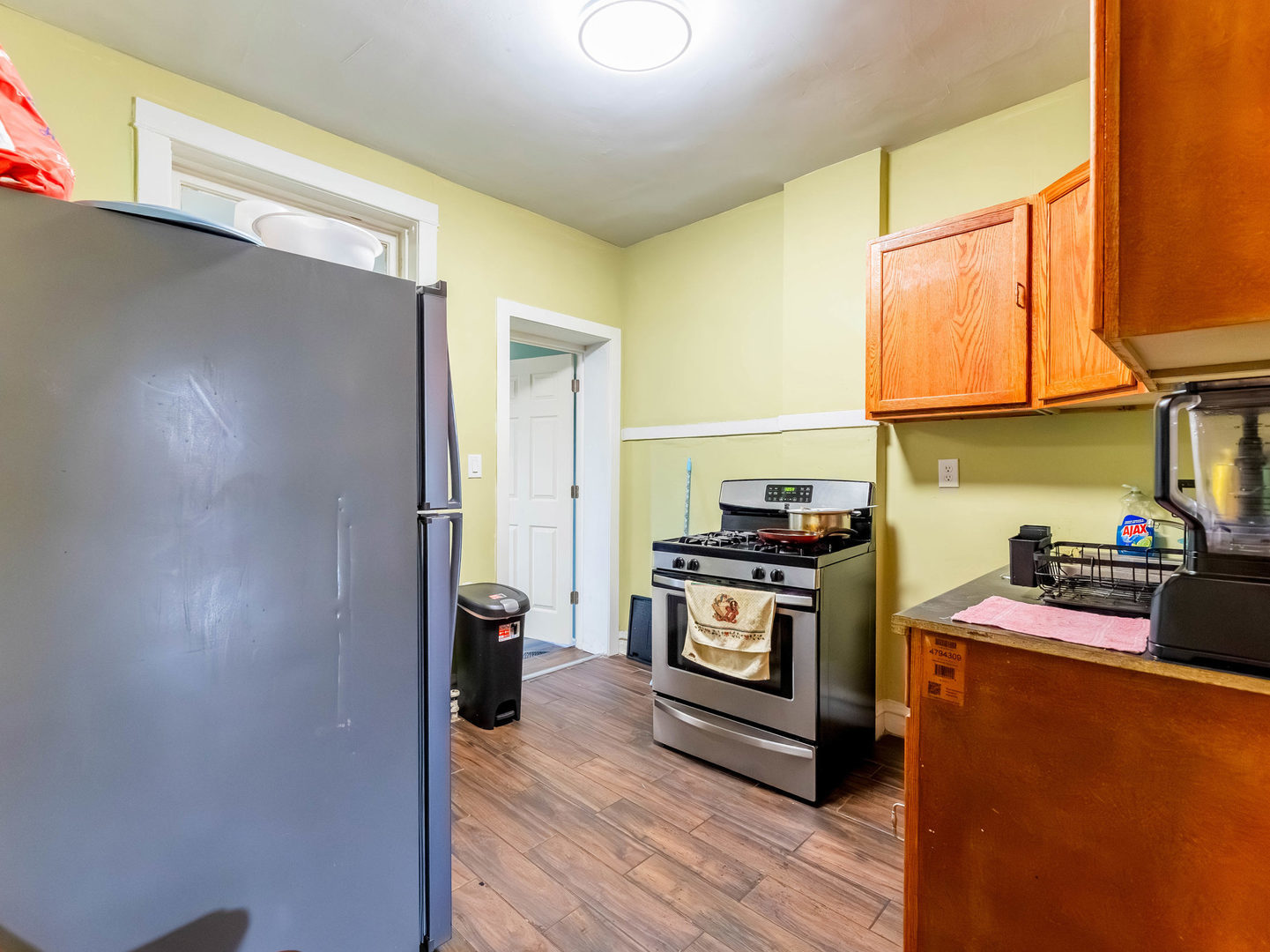 4747 West Monroe Street Chicago, IL 60644 - Photo 7 of 25 a kitchen with stainless steel appliances granite countertop a stove a refrigerator and a wooden cabinets
