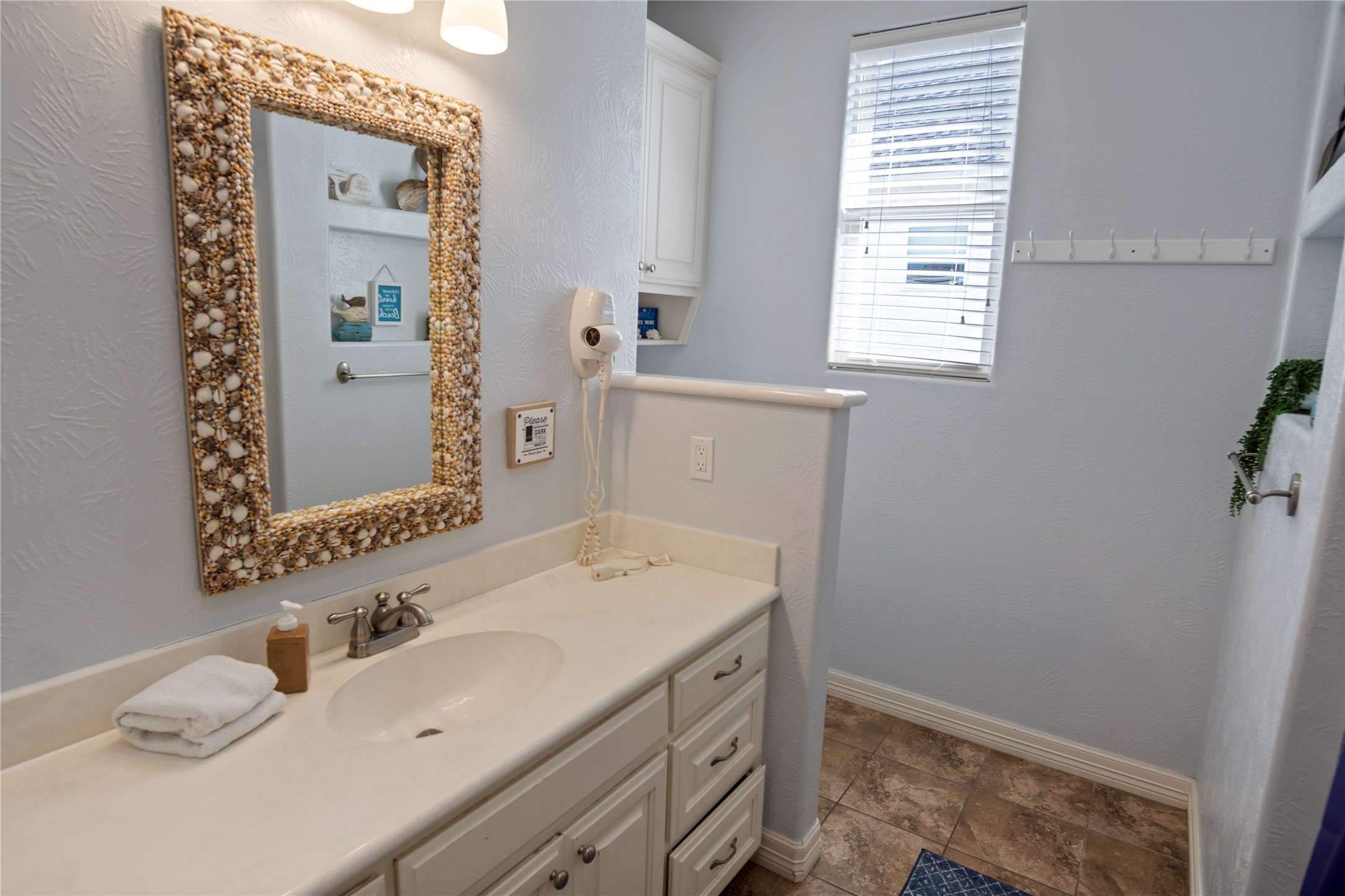 932 Kent Crystal Beach, TX 77650 - Photo 17 of 37 a bathroom with a sink a vanity and a mirror