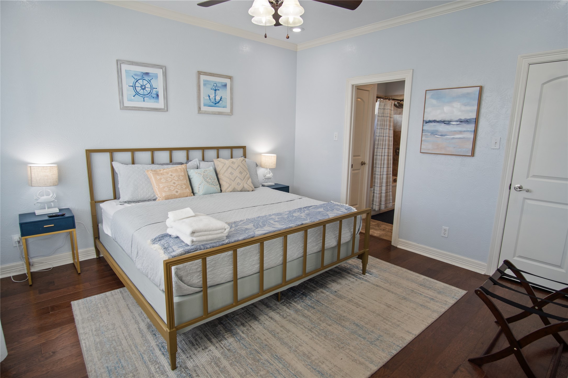 932 Kent Crystal Beach, TX 77650 - Photo 24 of 37 a large bed sitting in a bedroom next to a chandelier