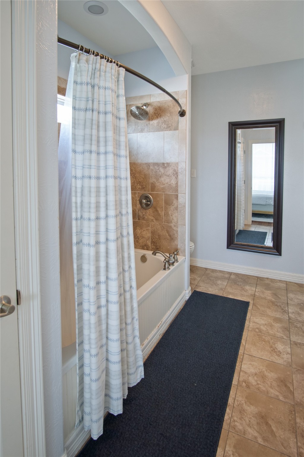 932 Kent Crystal Beach, TX 77650 - Photo 29 of 37 a view of a bathroom with a shower curtain