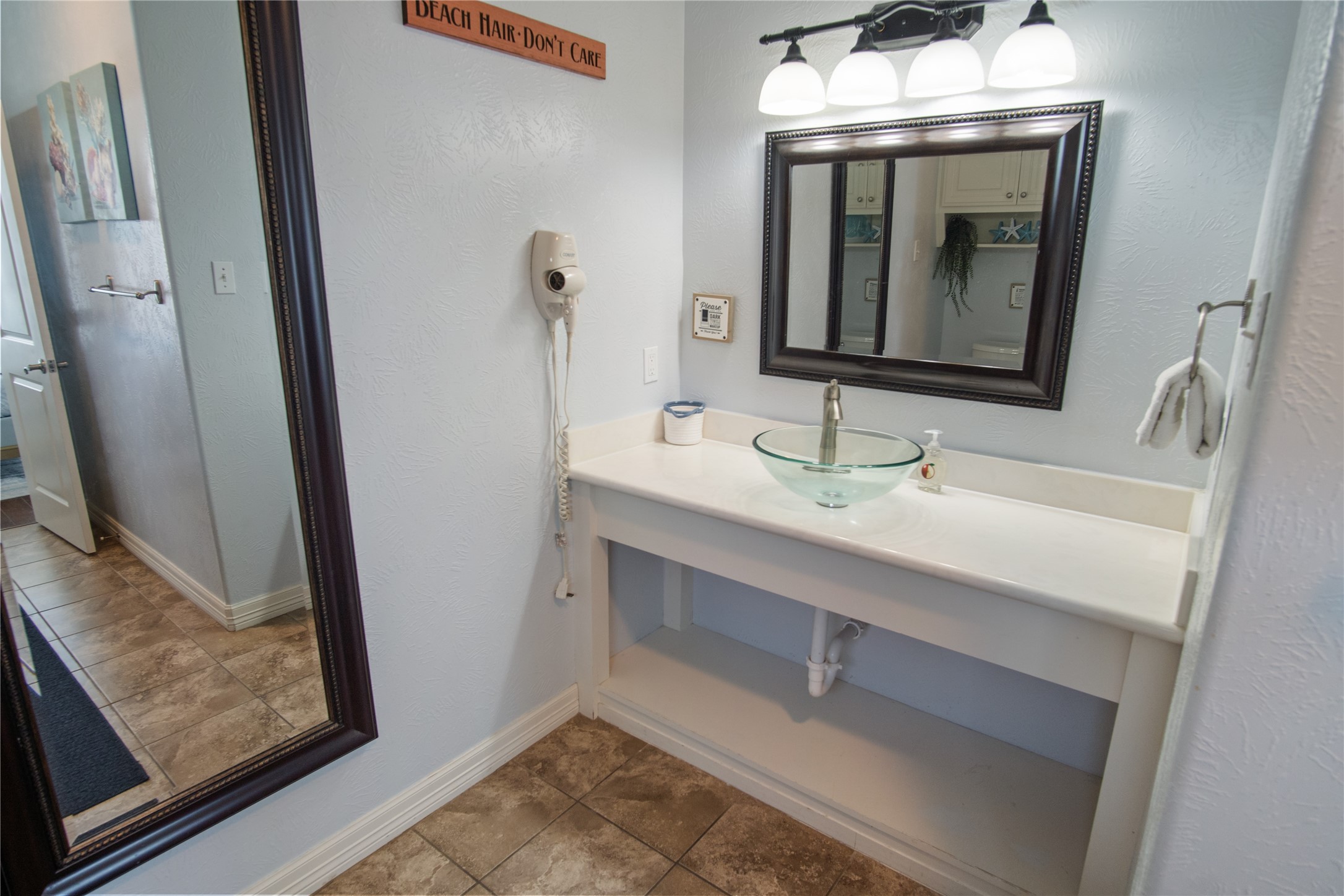 932 Kent Crystal Beach, TX 77650 - Photo 30 of 37 a bathroom with a sink and a mirror