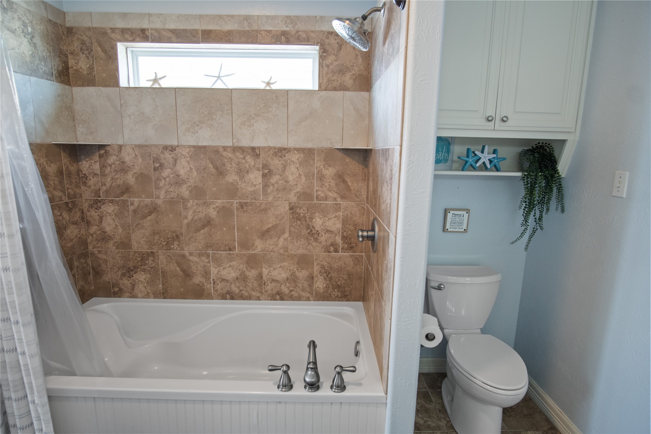 932 Kent Crystal Beach, TX 77650 - Photo 31 of 37 a bathroom with a toilet and a bathtub