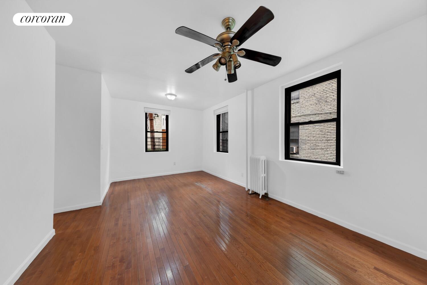 21-28 35th Street, Unit 1H Queens, NY 11105 - Photo 3 of 8 a view of empty room with wooden floor