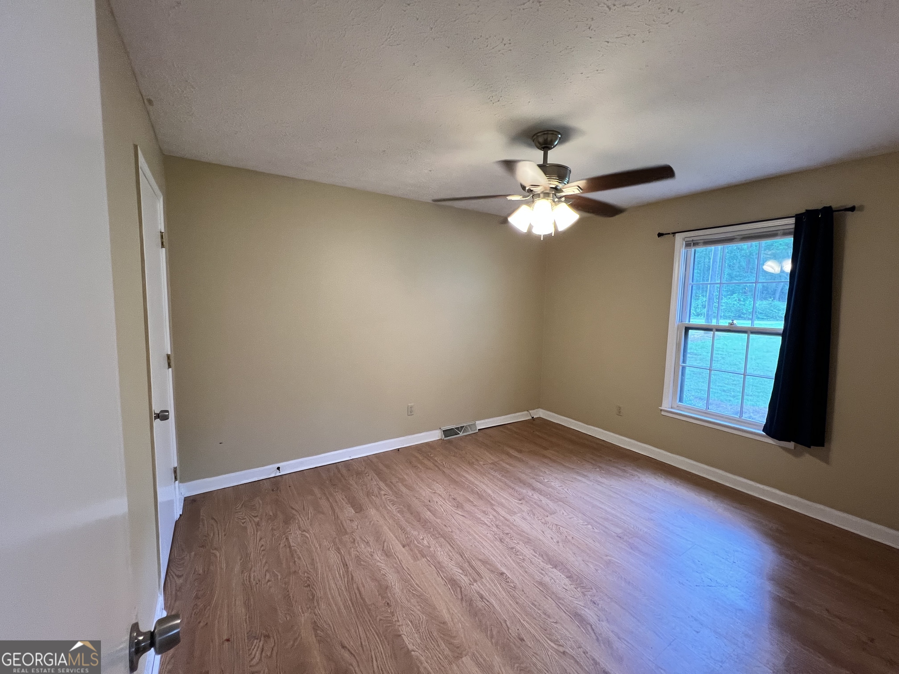 32 Ford Drive Southeast Rome, GA 30161 - Photo 18 of 49 an empty room with chandelier fan and windows