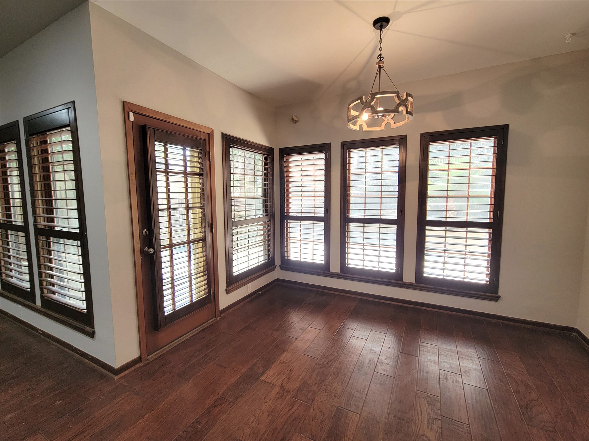 10 Dovewood Place The Woodlands, TX 77381 - Photo 14 of 34 a view of an empty room with wooden floor and a window