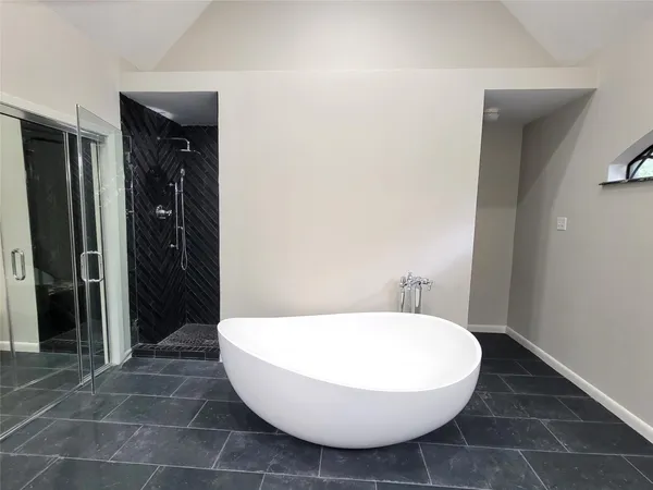 a bathroom with a bathtub and shower