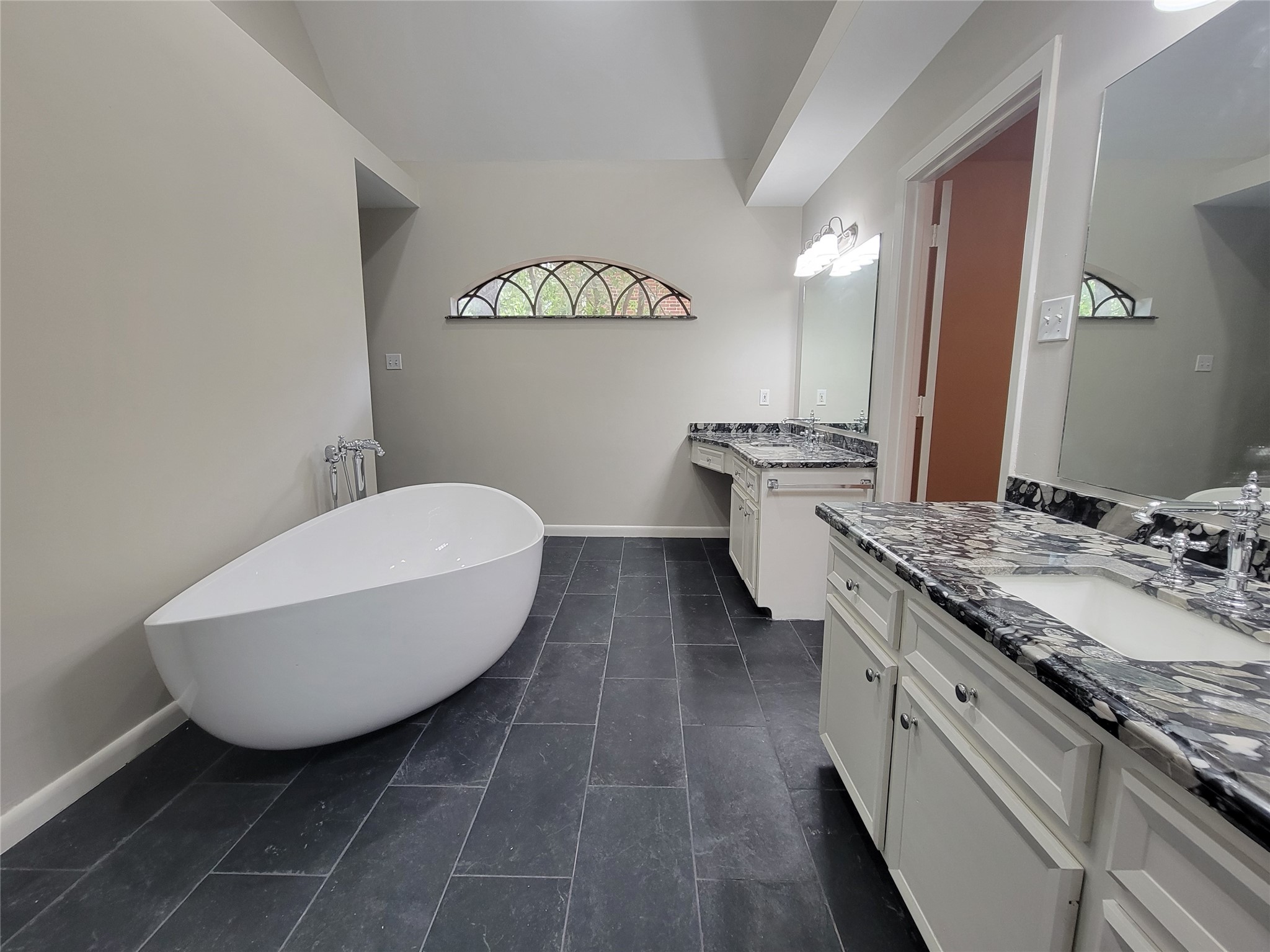 10 Dovewood Place The Woodlands, TX 77381 - Photo 22 of 34 a spacious bathroom with a granite countertop sink a toilet mirror and a bathtub