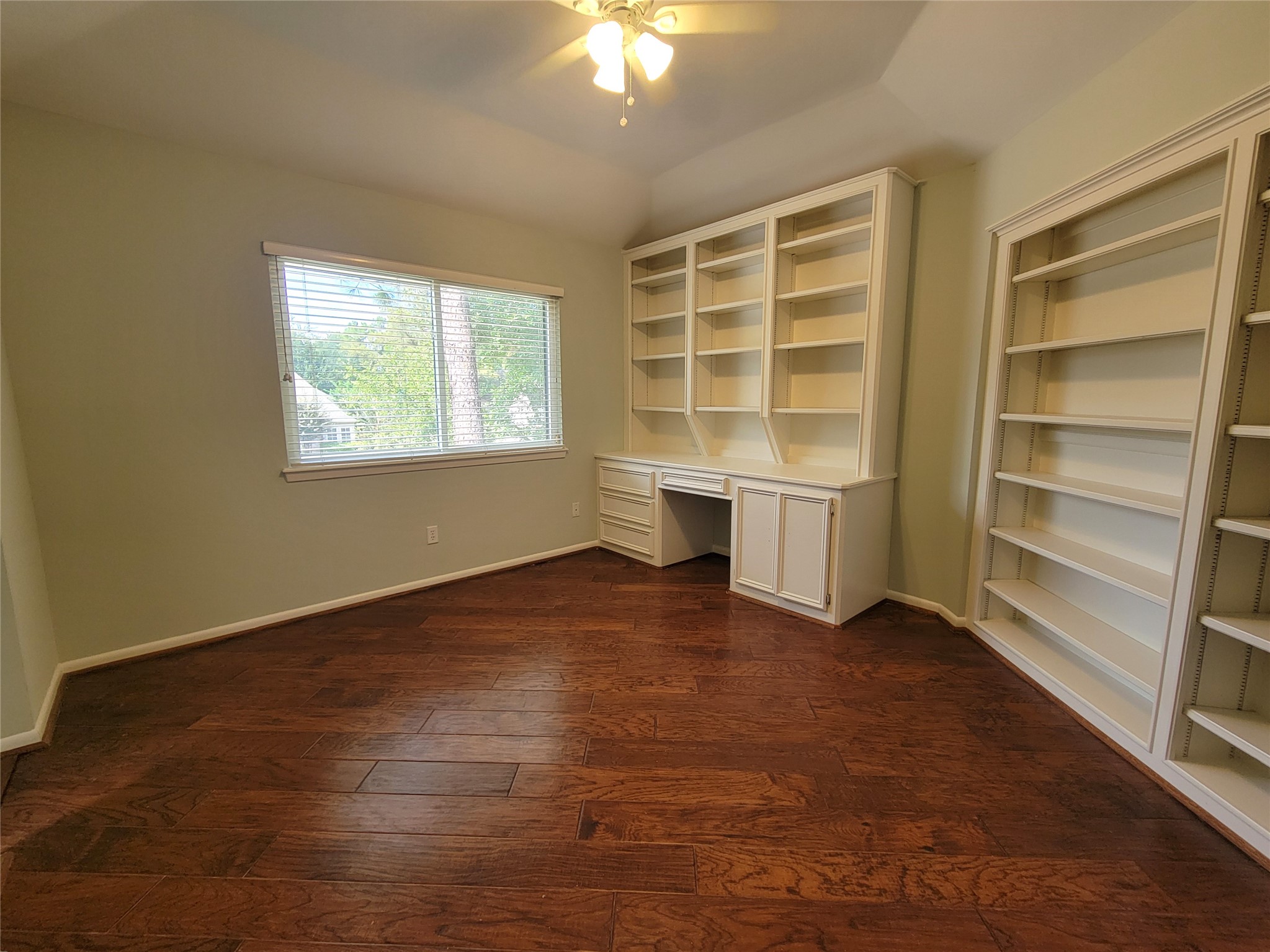 10 Dovewood Place The Woodlands, TX 77381 - Photo 27 of 34 a view of an empty room with a window and wooden floor