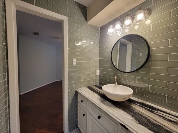 a bathroom with a sink toilet a mirror and vanity