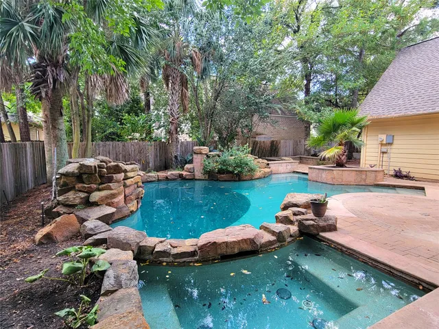 a view of a lake with lawn chairs under an umbrella