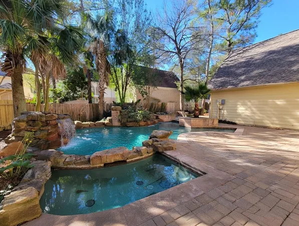 a view of a backyard with swimming pool