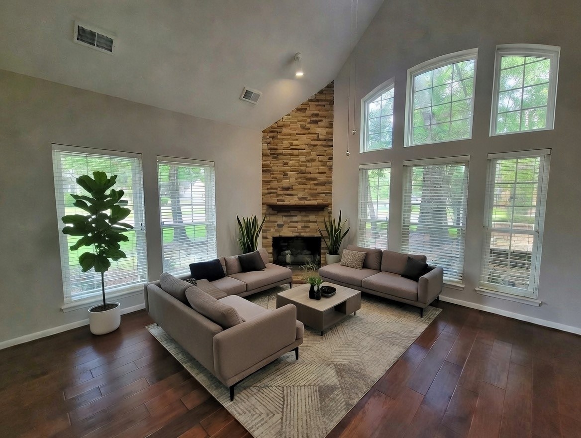 10 Dovewood Place The Woodlands, TX 77381 - Photo 6 of 34 a living room with fireplace furniture and a large window
