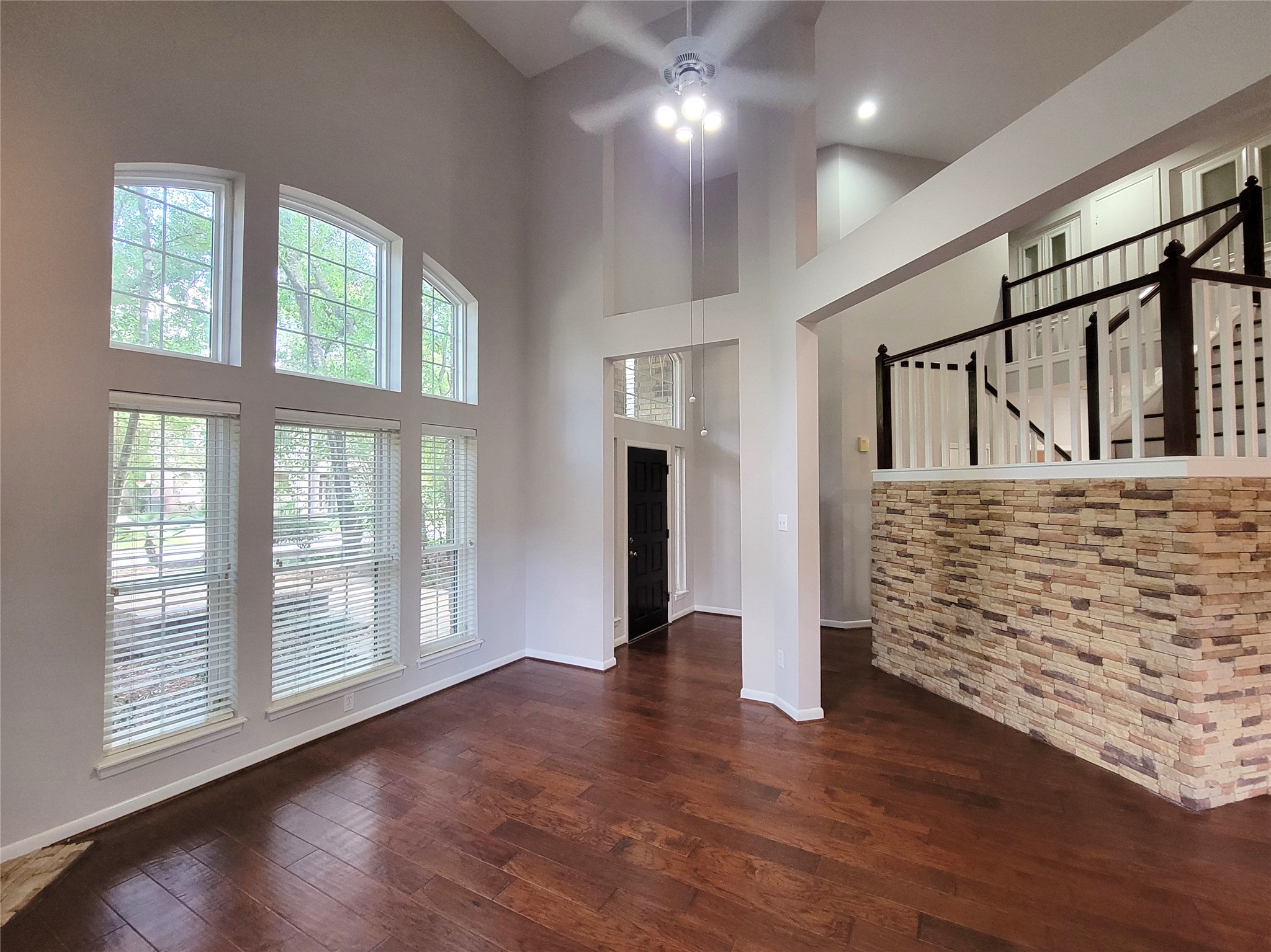 10 Dovewood Place The Woodlands, TX 77381 - Photo 8 of 34 a view of an empty room with wooden floor and windows