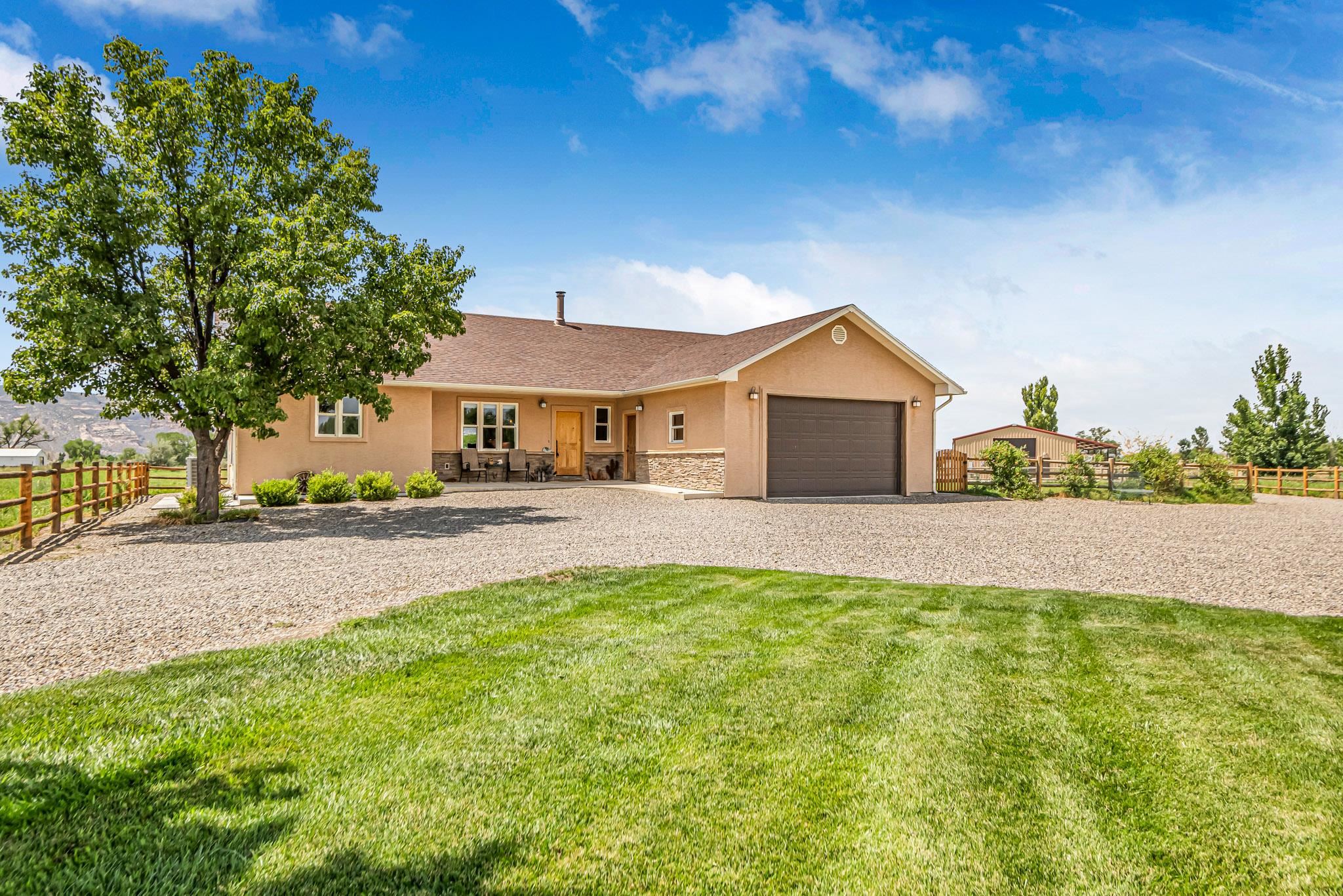 985-20 20 1/2 Road Fruita, CO 81521 - Photo 11 of 42 a front view of a house with a yard and trees