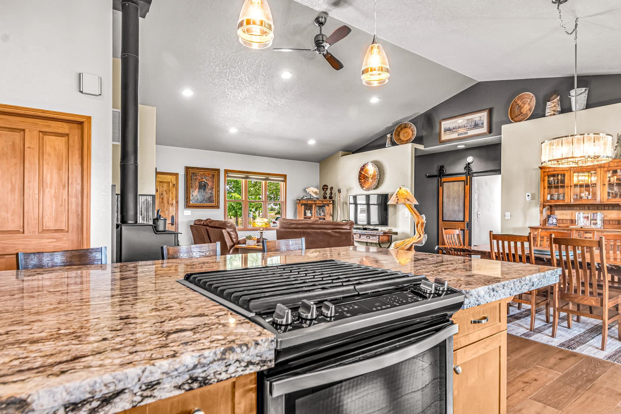 985-20 20 1/2 Road Fruita, CO 81521 - Photo 17 of 42 a kitchen with stainless steel appliances granite countertop a stove top oven a dining table and chairs with wooden floor