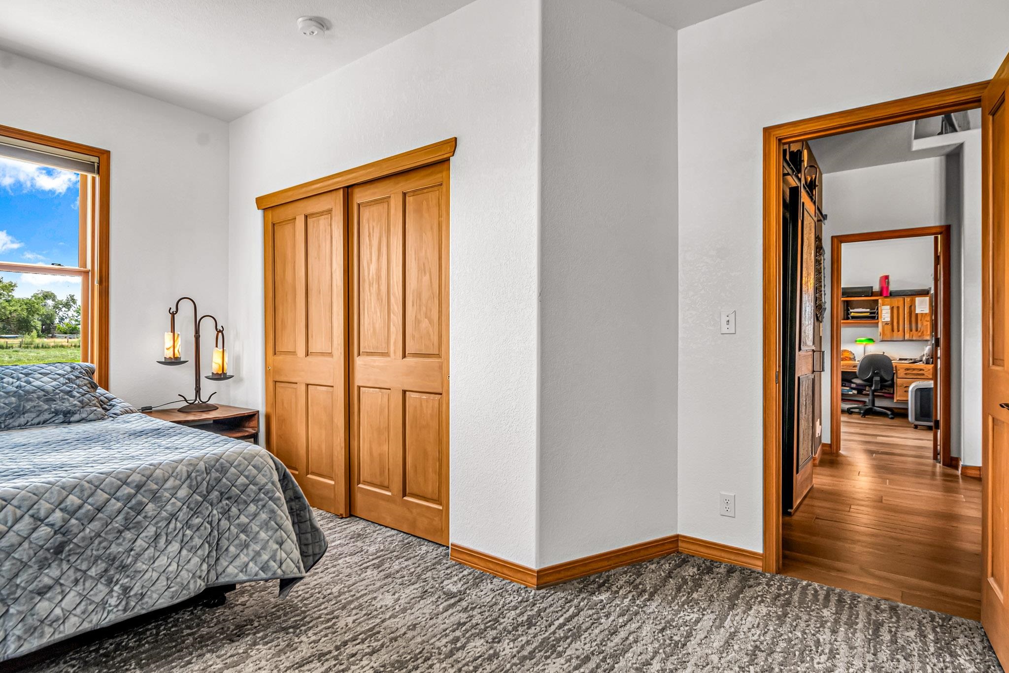985-20 20 1/2 Road Fruita, CO 81521 - Photo 29 of 42 a bedroom with a bed and wooden floor