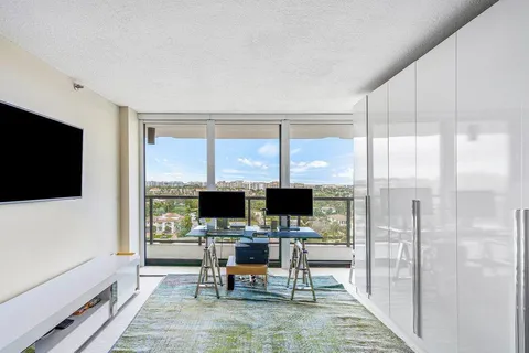 a view of a livingroom with wooden floor and a flat screen tv