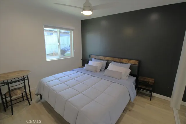 a bedroom with a bed and a window