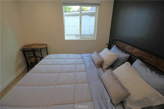 a bedroom with a bed and window