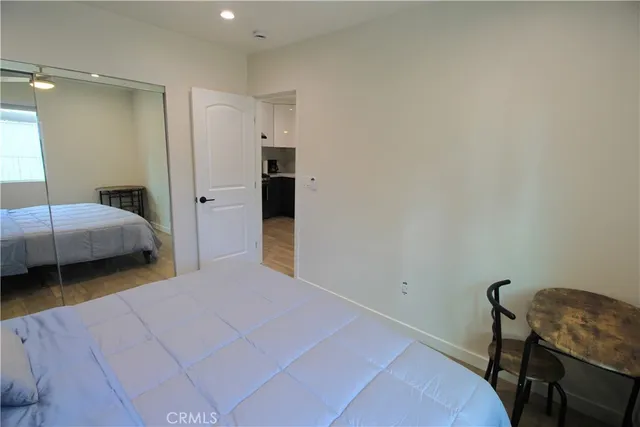 a bedroom with a bed and a chair