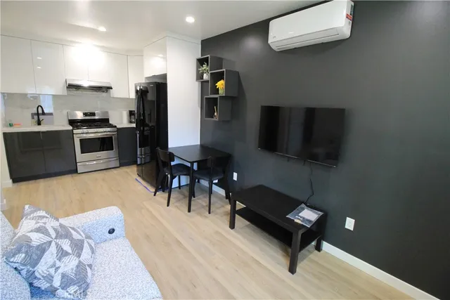 a living room with furniture and a kitchen view