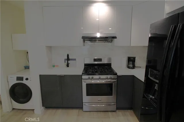 a kitchen with a stove and a refrigerator