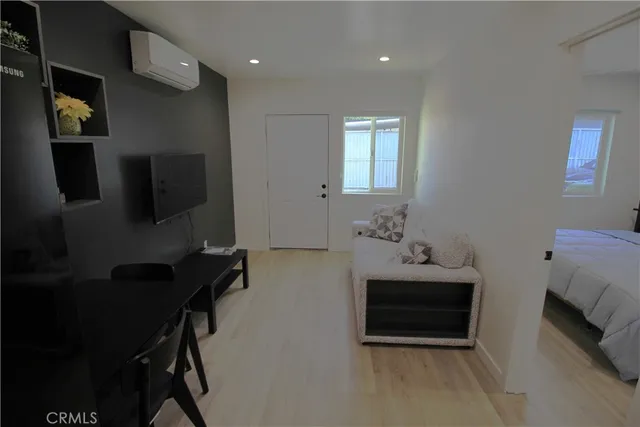 a bedroom with furniture and a flat screen tv