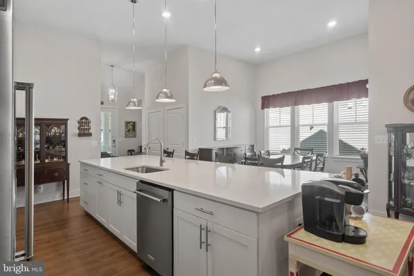 a large white kitchen with a large window
