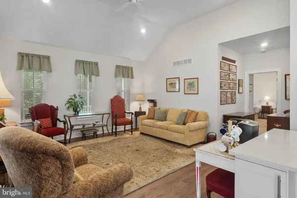 a living room with stainless steel appliances furniture dining table and chairs