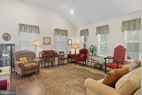 a living room with furniture a lamp and a window