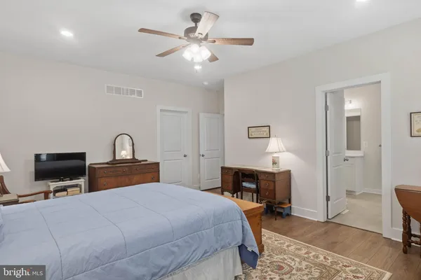 a bedroom with a bed a desk and chair