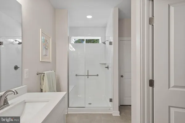a bathroom with a sink vanity and a mirror