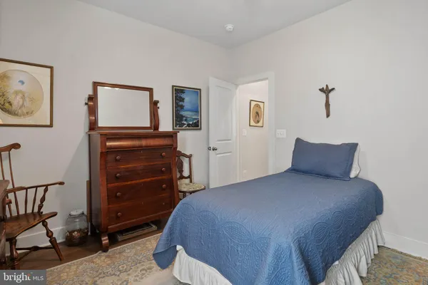 a bedroom with a bed and a dresser