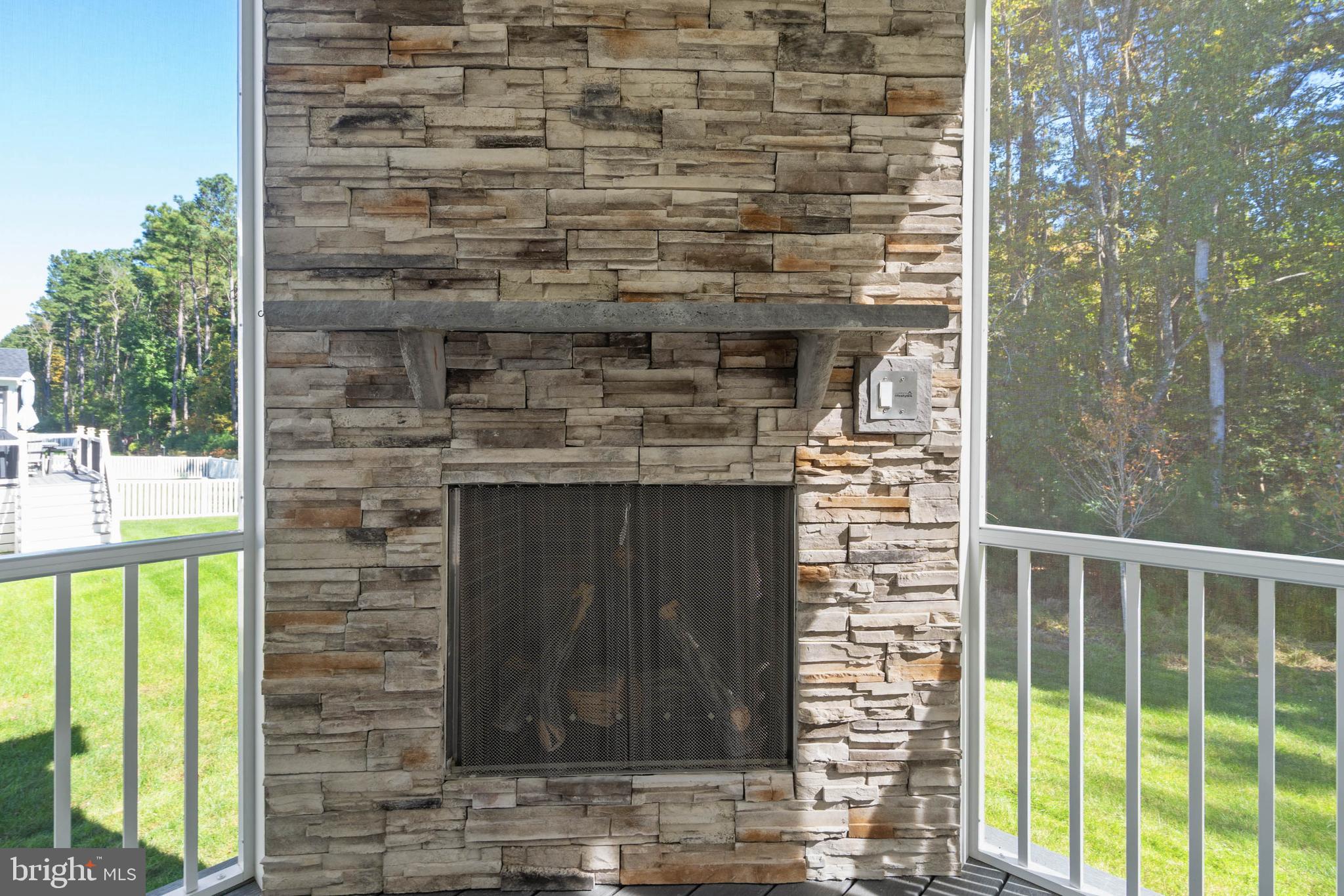 18573 Emerson Way Georgetown, DE 19947 - Photo 33 of 51 Stacked Stone Screen Porch Corner Fireplace