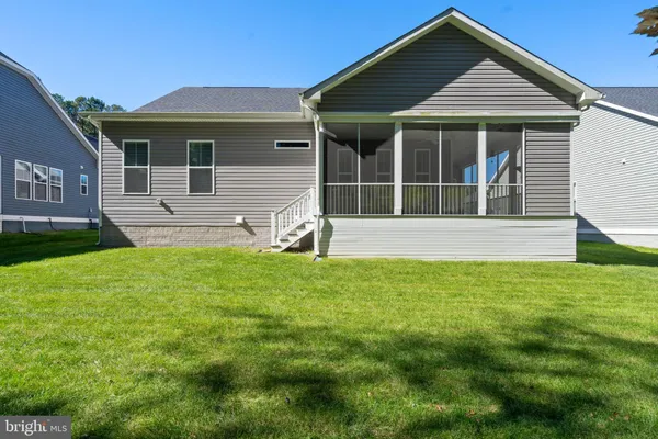 a view of house with backyard