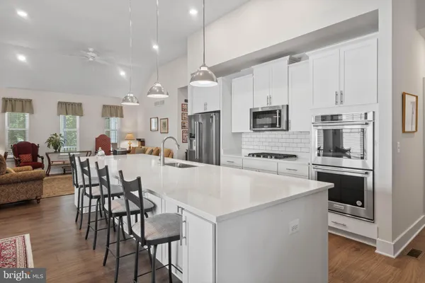 a large kitchen with kitchen island a large island in the center