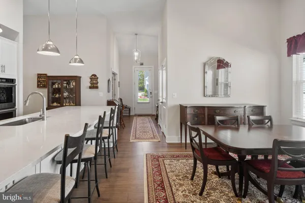 a dining room with furniture and wooden floor