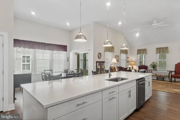 a large white kitchen with a large window and stainless steel appliances