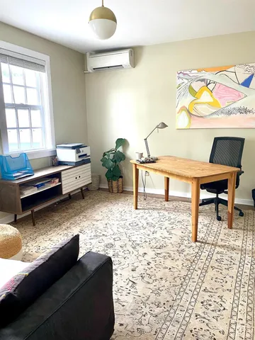 a living room with furniture and a rug