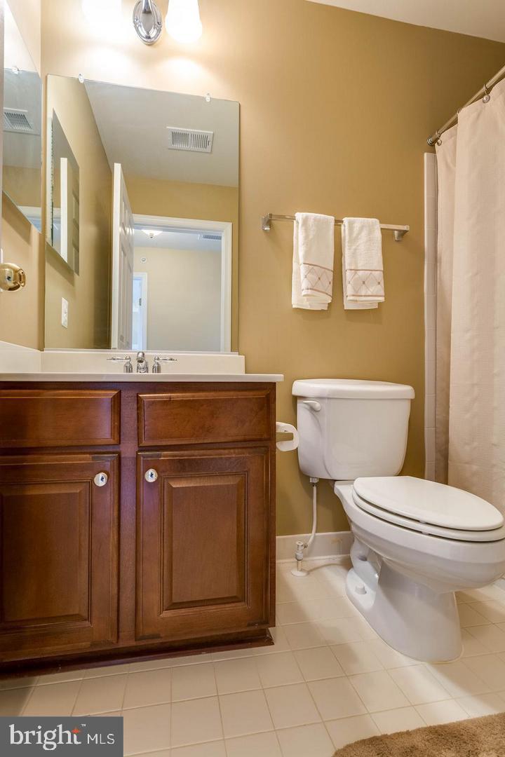 14233 B St Germain Drive, Unit 6 Centreville, VA 20121 - Photo 12 of 13 a bathroom with a toilet a sink and a mirror