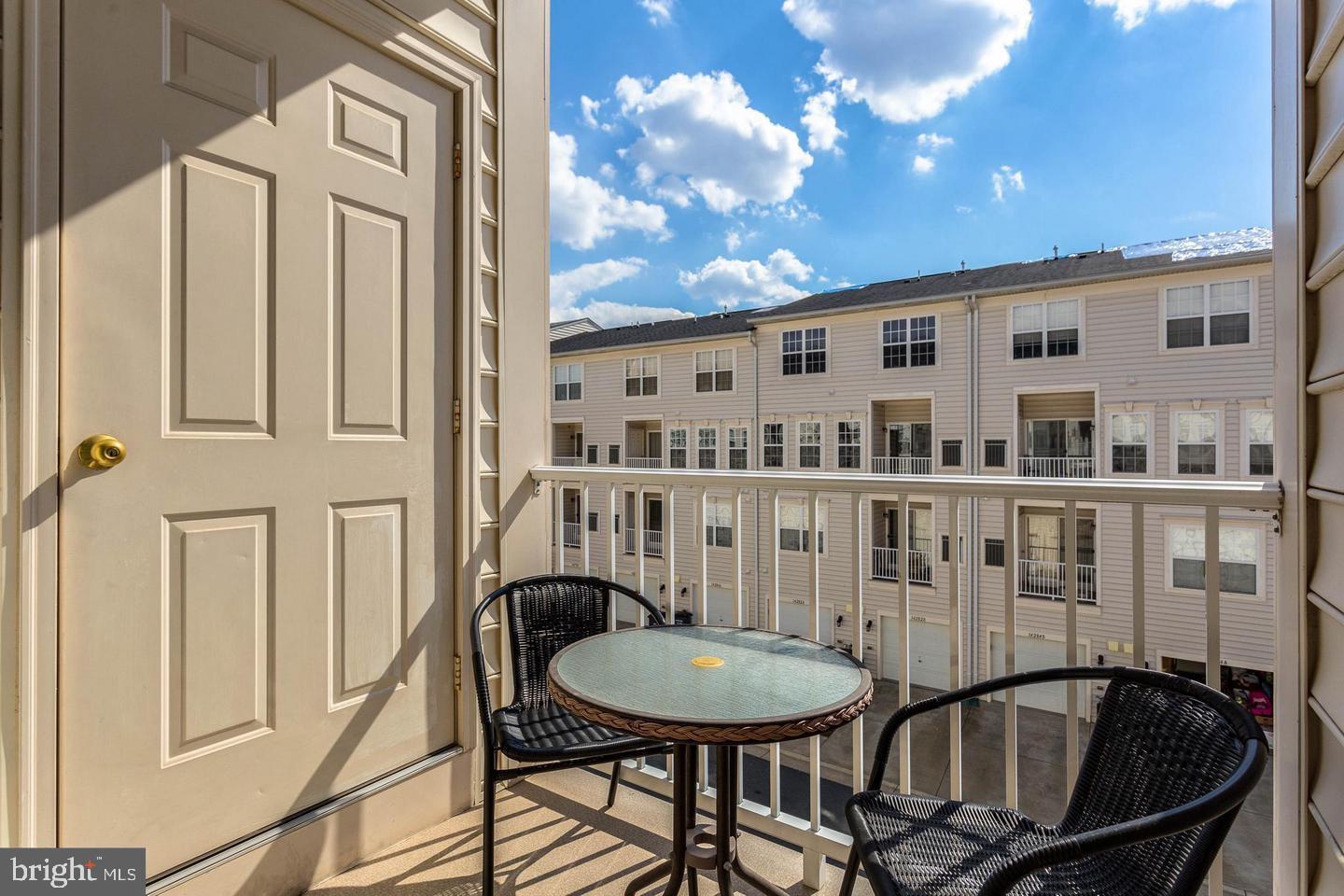 14233 B St Germain Drive, Unit 6 Centreville, VA 20121 - Photo 13 of 13 a balcony view with a dining table and chairs