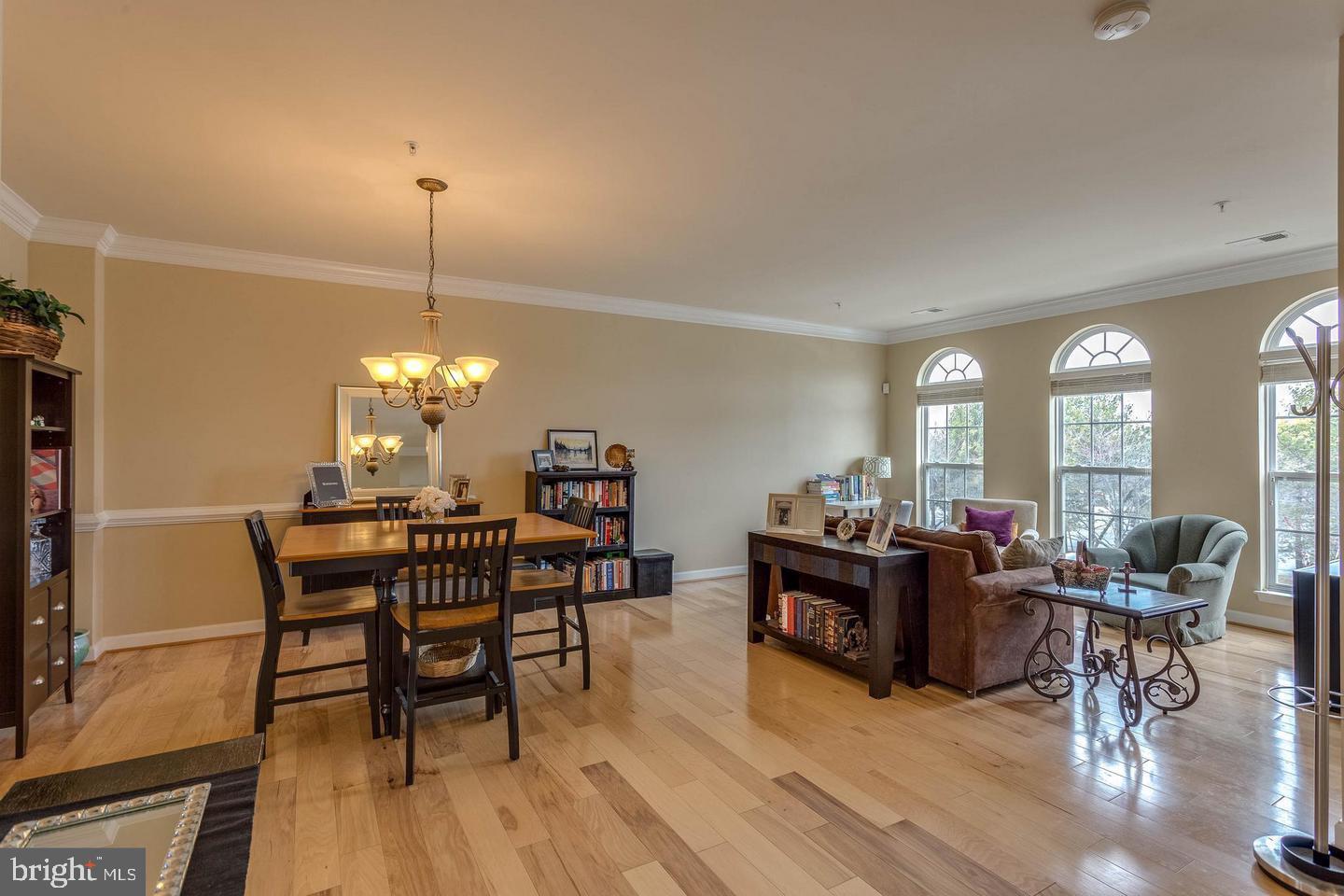14233 B St Germain Drive, Unit 6 Centreville, VA 20121 - Photo 3 of 13 a view of a dining room with furniture window and wooden floor
