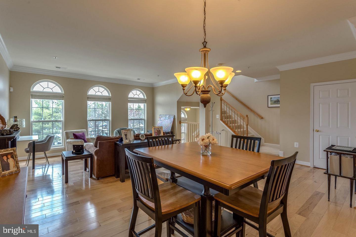 14233 B St Germain Drive, Unit 6 Centreville, VA 20121 - Photo 4 of 13 a view of a dining room with furniture window and wooden floor
