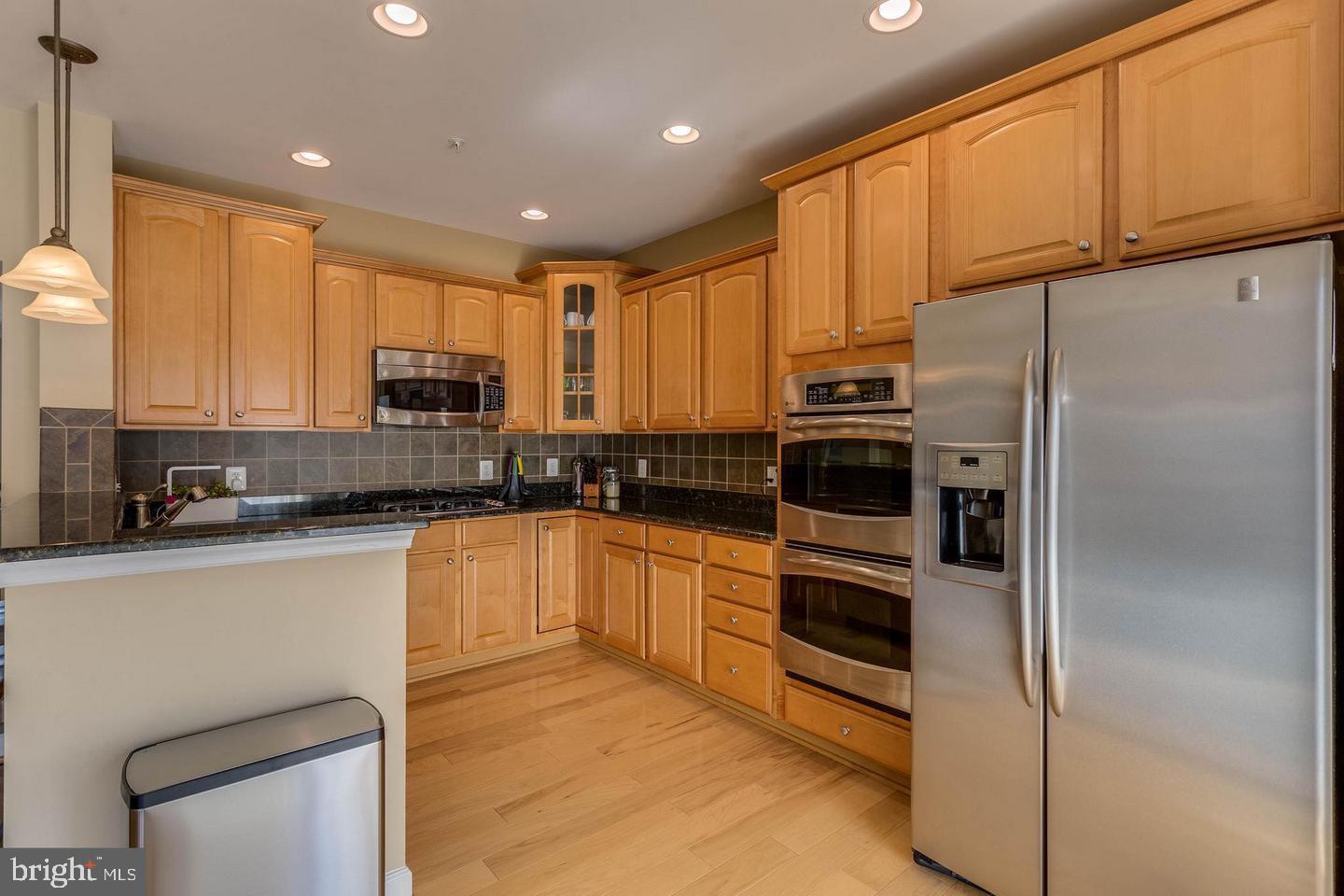 14233 B St Germain Drive, Unit 6 Centreville, VA 20121 - Photo 6 of 13 a kitchen with stainless steel appliances granite countertop a refrigerator sink and microwave