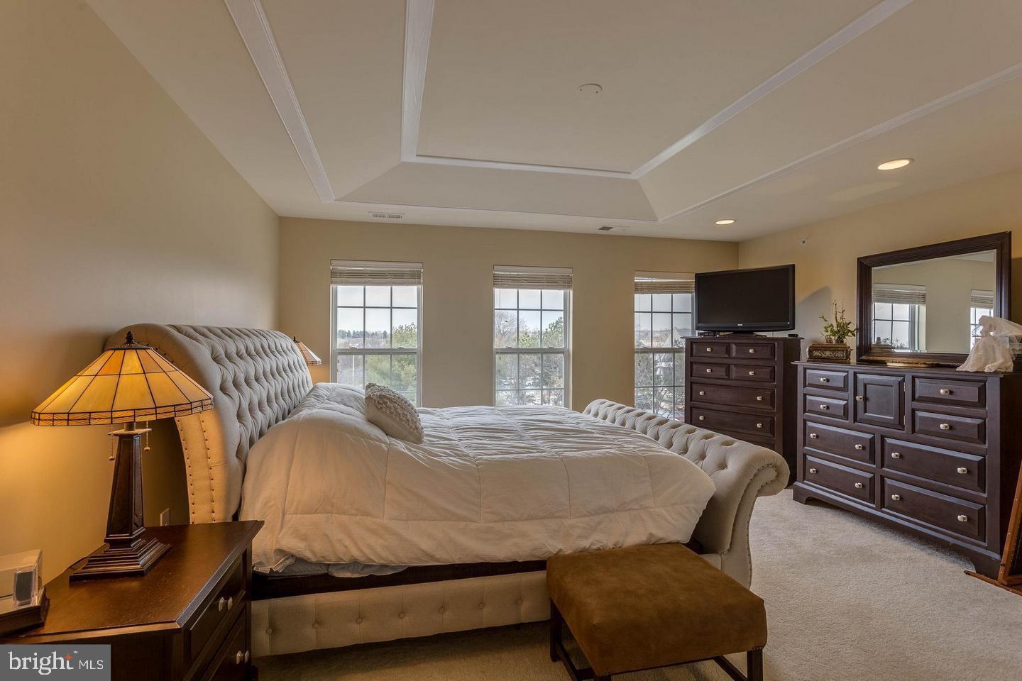 14233 B St Germain Drive, Unit 6 Centreville, VA 20121 - Photo 9 of 13 a bedroom with a bed dresser and mirror