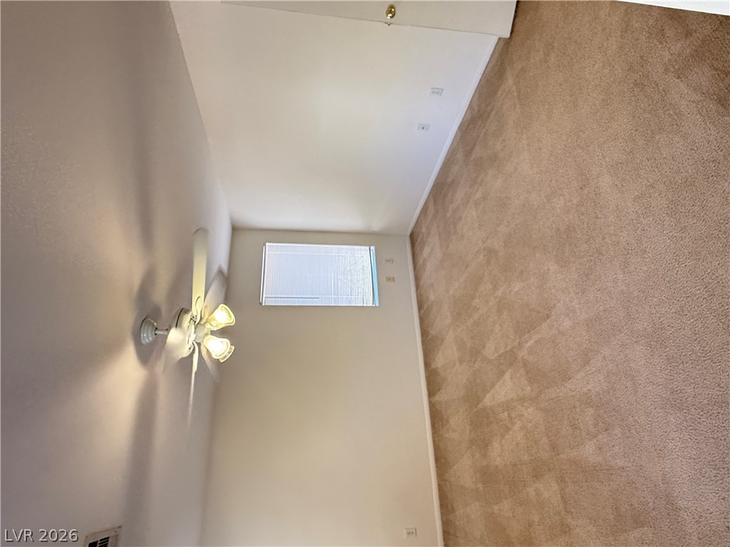 8108 Roundup Ridge Street Las Vegas, NV 89131 - Photo 19 of 21 A well-maintained carpeted room offers comfortable living with natural light and efficient climate control.